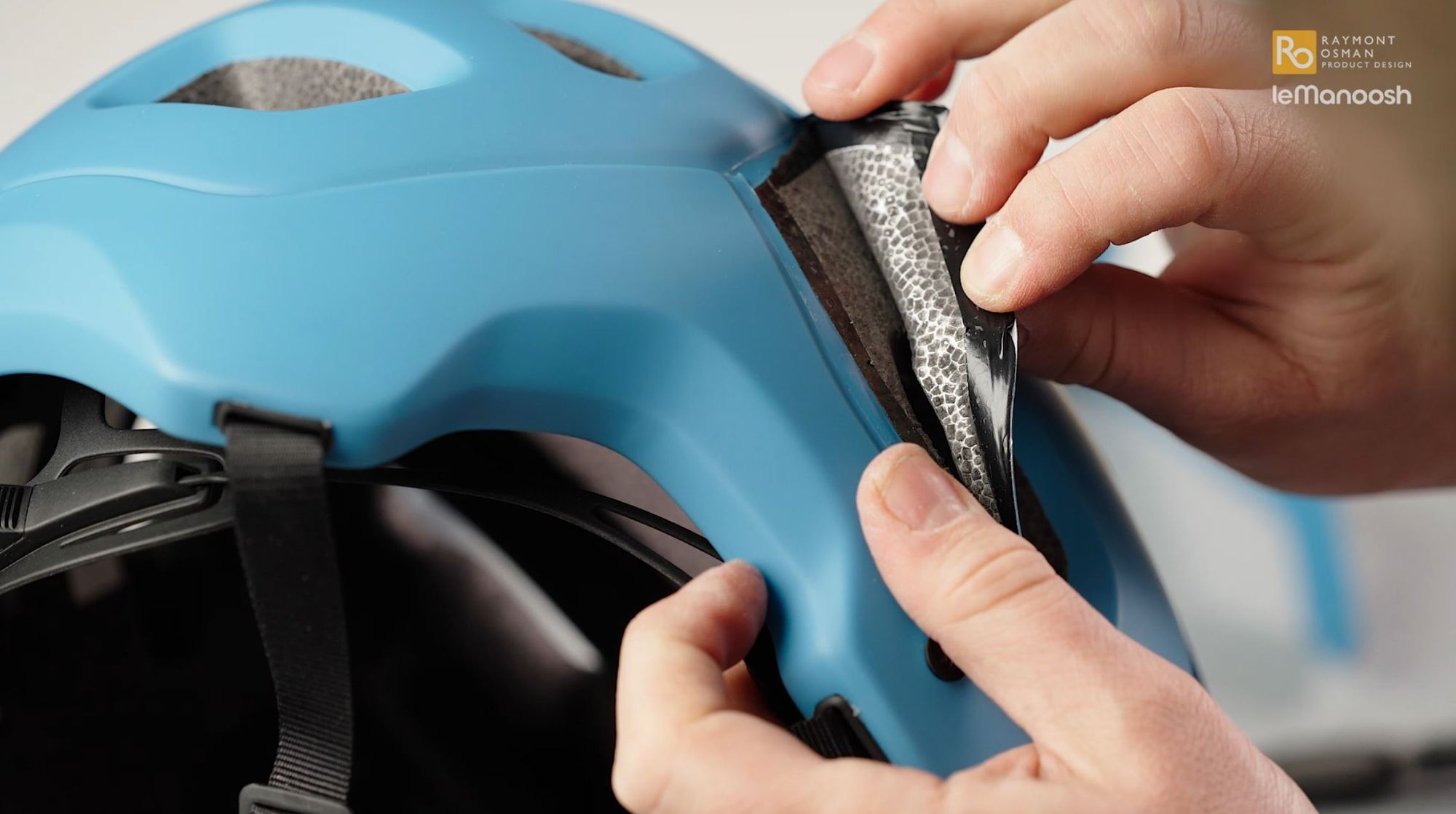 An engineer examines the construction of a bike helmet